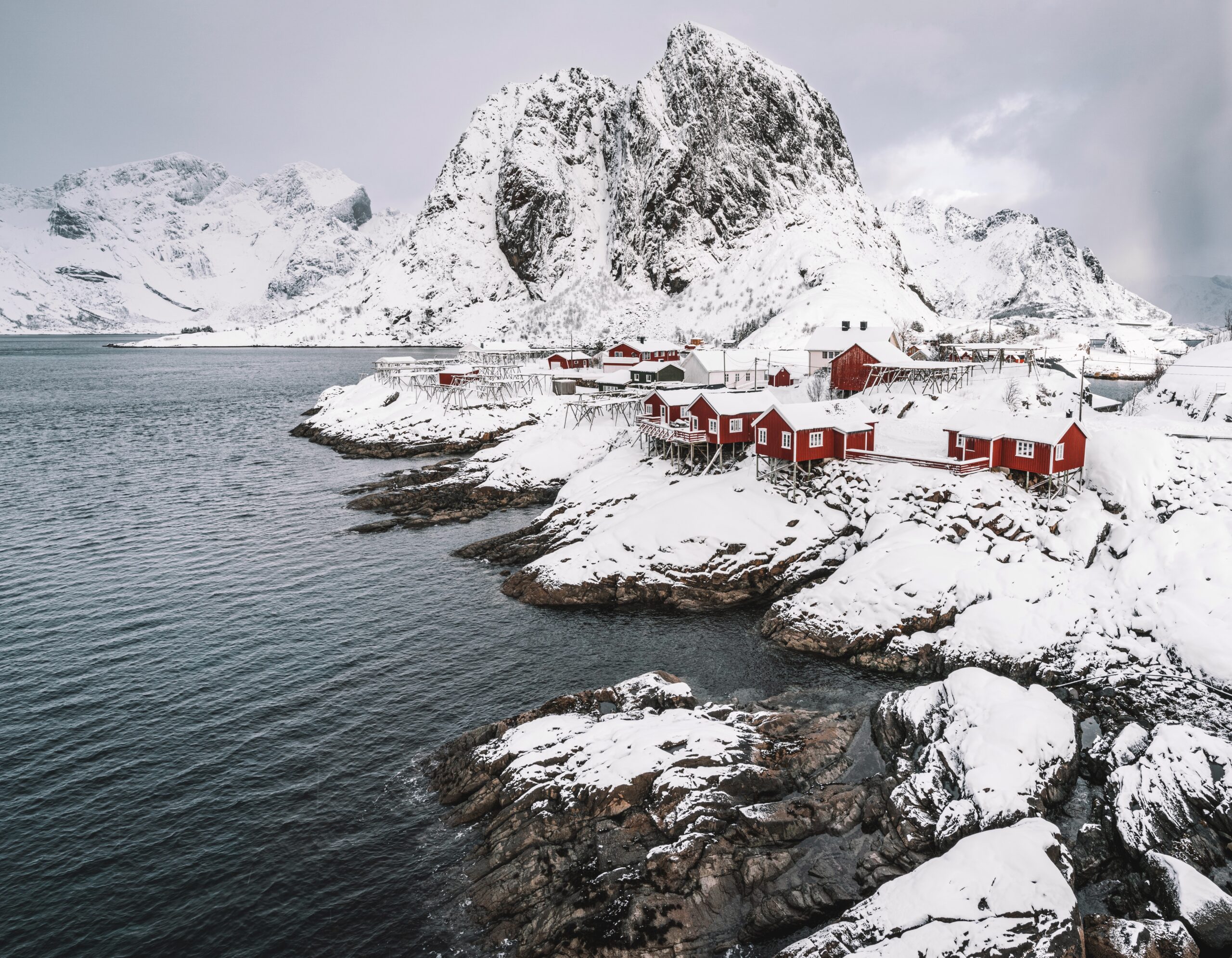Hamnoy in winter after snowfall, next to the coast.