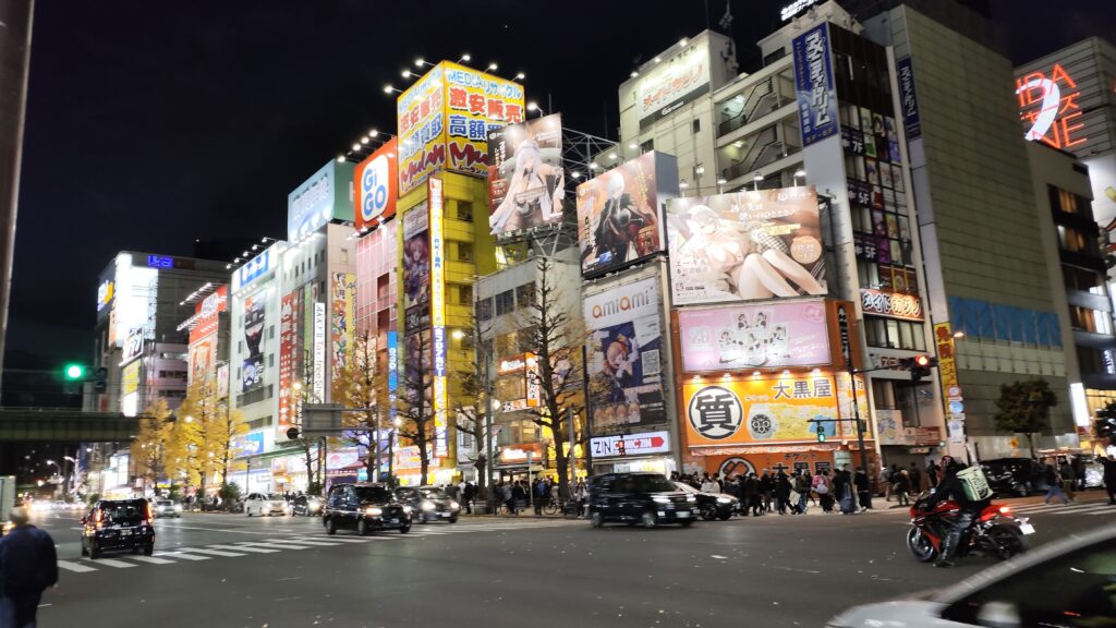 Night view of Akihabara Chuo-dori Street with cars and ads
